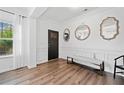 Bright foyer features decorative mirrors, elegant trim, and beautiful hardwood floors, creating a welcoming entrance at 3360 Meadow Grass Dr, Dacula, GA 30019
