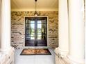 Elegant double front doors framed by white columns and brick, creating a grand entrance at 6110 Read Rd, Suwanee, GA 30024