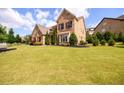 Beautifully landscaped front yard of a two-story brick home in a suburban neighborhood at 6110 Read Rd, Suwanee, GA 30024