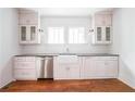 Charming kitchen with stainless dishwasher, farmhouse sink, and white subway tile backsplash at 23 Clifton Se St, Atlanta, GA 30317