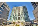 Modern high-rise residential building with a porte-cochere and well-manicured landscaping at 361 17Th Nw St # 1603, Atlanta, GA 30363