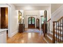Spacious foyer with hardwood floors and a staircase leading to the upper level at 13037 Overlook Pass, Roswell, GA 30075