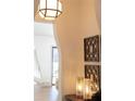 Close-up of foyer showcasing decorative art, sconces, and table with decorative lamps at 375 Chattahoochee St, Roswell, GA 30075