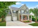 Charming two-story home with brick accents, covered porch, manicured lawn, and a two-car garage at 1037 Panoramic Pte, Buford, GA 30518