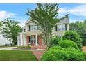 Charming two-story home with brick accents, covered porch, manicured lawn, and a two-car garage at 1037 Panoramic Pte, Buford, GA 30518