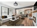 Bright open-concept living room with stone fireplace, hardwood floors, and a seamless flow to the dining area at 1393 Westview Sw Dr, Atlanta, GA 30310