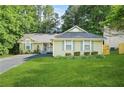 Inviting single-story home featuring a well-kept lawn and traditional design elements at 2107 Sandtree Sw Ct, Atlanta, GA 30331