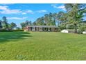 Well-manicured lawn leading up to a classic brick home with black shutters and a welcoming entrance at 4129 Pepperdine Dr, Decatur, GA 30034