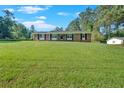Spacious front yard of a well-kept single-story brick home with black shutters at 4129 Pepperdine Dr, Decatur, GA 30034