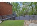 Private backyard featuring a wooden fence, lush lawn, and a charming stone pathway at 1025 Saint Marks Walk, Suwanee, GA 30024