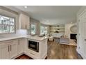 Open-concept kitchen with white cabinets, stainless steel appliances, and seamless flow to the living area at 5567 Stapleton Dr, Dunwoody, GA 30338