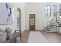 Bright foyer with hardwood floors, high ceilings, and a staircase with an iron railing at 56 Pine St, Roswell, GA 30075