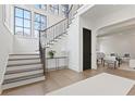 Elegant staircase with modern railing, hardwood treads, and white risers in a bright foyer at 56 Pine St, Roswell, GA 30075