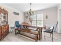 Dining room features a wooden table, mix of seating and decor with natural light from a window at 959 Vendue Dr, Lawrenceville, GA 30044