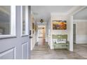 Bright and inviting foyer with light-colored walls, a decorative bench, and hardwood floors at 959 Vendue Dr, Lawrenceville, GA 30044