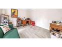 Versatile room with light gray hardwood flooring and ample space, decorated with eclectic items at 959 Vendue Dr, Lawrenceville, GA 30044