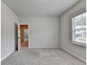 Neutral bedroom with a window, carpet, and a view into the hall, bright and move-in ready at 1620 Branthaven Ln, Auburn, GA 30011