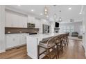 Modern kitchen featuring white cabinetry, stainless steel appliances, a large island, and stylish pendant lighting at 1768 Evenstad Way, Smyrna, GA 30080