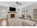 Inviting living room with a stone fireplace, plantation shutters, and plush seating, creating a cozy ambiance at 1768 Evenstad Way, Smyrna, GA 30080