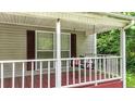 Inviting front porch with a charming swing and wood flooring at 232 S Candler St, Villa Rica, GA 30180