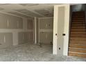 Unfinished basement with stairs and framed walls, ready for customization to suit your needs at 27 Benscot Dr, Austell, GA 30106