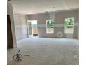 Spacious living room under construction with ample natural light and a door to the outdoor at 27 Benscot Dr, Austell, GA 30106