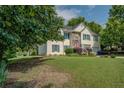 Charming two-story home with a well-manicured lawn and a pop of color from the red front door at 3870 Michaels Creek Ct, Loganville, GA 30052