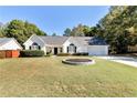 Charming single-story home with a well-manicured lawn and inviting curb appeal on a sunny day at 540 Windermere Dr, Loganville, GA 30052
