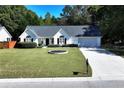 Beautiful one-story home with a well-maintained lawn and an inviting front exterior on a sunny day at 540 Windermere Dr, Loganville, GA 30052