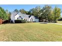 A charming single-story home with an expansive, well-manicured lawn creating a welcoming exterior at 540 Windermere Dr, Loganville, GA 30052