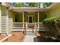 Covered front porch with ceiling fans and a fenced entry, offering a cozy and inviting entrance to this charming home at 261 Township Dr, Hiram, GA 30141