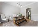 Bright dining room with a wooden table, bench, and stylish light fixture at 3174 Vickery Ne Dr, Marietta, GA 30066