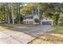 Charming two-story home features a well-manicured lawn, fresh paint, shutters, and an attached two-car garage at 4045 White Oak Sw Ln, Lilburn, GA 30047