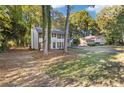 Charming two-story home features a well-manicured lawn, fresh paint, shutters, and an attached two-car garage at 4045 White Oak Sw Ln, Lilburn, GA 30047