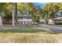 Charming two-story home features a well-manicured lawn, fresh paint, shutters, and an attached two-car garage at 4045 White Oak Sw Ln, Lilburn, GA 30047