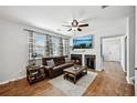 Cozy living room boasts a fireplace, ceiling fan, and large windows for ample natural light at 505 Rendezvous Rd, Acworth, GA 30102