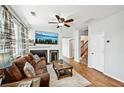 Comfortable living room featuring a fireplace, ceiling fan, and staircase access at 505 Rendezvous Rd, Acworth, GA 30102