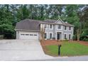 Charming two-story home with a manicured lawn and a two-car garage at 1368 Christiana Dr, Lawrenceville, GA 30043