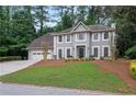 Charming two-story home with a manicured lawn and a two-car garage at 1368 Christiana Dr, Lawrenceville, GA 30043