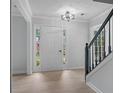 Bright foyer featuring a modern light fixture and light-colored wood flooring at 1368 Christiana Dr, Lawrenceville, GA 30043