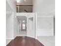 Bright foyer boasts hardwood floors, neutral walls, and a view of the upper level landing at 1736 Dylan Pl, Lawrenceville, GA 30043
