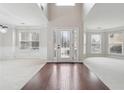 Grand foyer with hardwood floors, decorative front door, large windows and neutral walls and carpeting at 1736 Dylan Pl, Lawrenceville, GA 30043