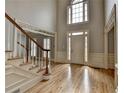 Grand foyer with high ceilings, hardwood floors, staircase, and detailed trim work at 340 Kincardine Way, Alpharetta, GA 30022