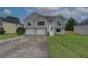 Two-story home with three-car garage, concrete driveway, and well-maintained lawn at 102 Peaceful Vw, Acworth, GA 30102