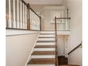 Elegant staircase with wooden steps and white railings leading to the upper level at 102 Peaceful Vw, Acworth, GA 30102