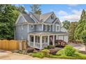 Charming home with a welcoming front porch, complemented by lush landscaping and a side entry garage at 111 Jeffrey Pl, Smyrna, GA 30082