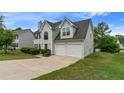 Charming two-story home featuring an attached two-car garage and beautiful front yard at 331 Overlook Turn Nw, Conyers, GA 30012