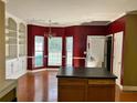 Kitchen featuring wood floors, chandelier, island, and bright red walls at 2653 Parkway Trl, Lithonia, GA 30058