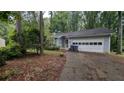 Charming home with a two-car garage and front yard ready for landscaping at 345 Deerwood Dr, Suwanee, GA 30024
