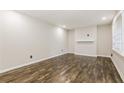 Bright living room featuring hardwood floors, fresh paint, and a large window at 6864 Maddox Rd, Morrow, GA 30260